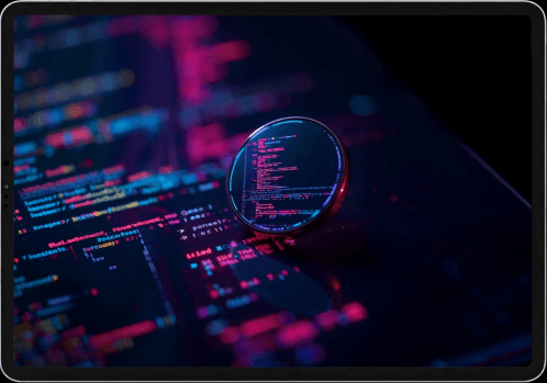 Magnifying glass zoomed in on colorful lines of code on a screen
