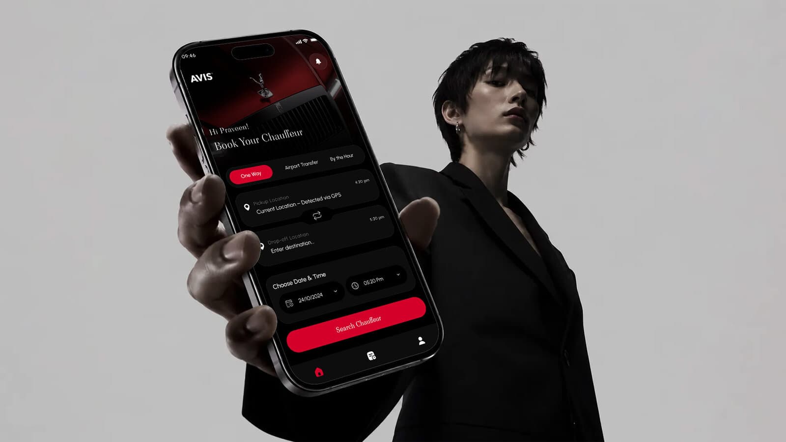 A hand holding the AVIS app open to the booking flow, showing trip type, pickup, and drop-off fields